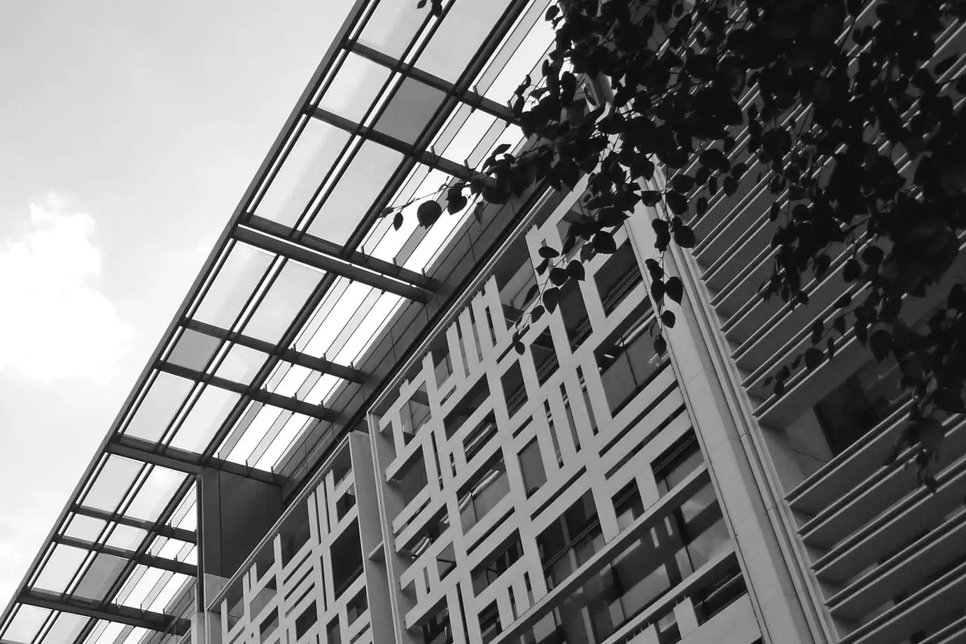 The coloured glass canopy and patterned facade of the Home Office building on Marsham Street, seen from below