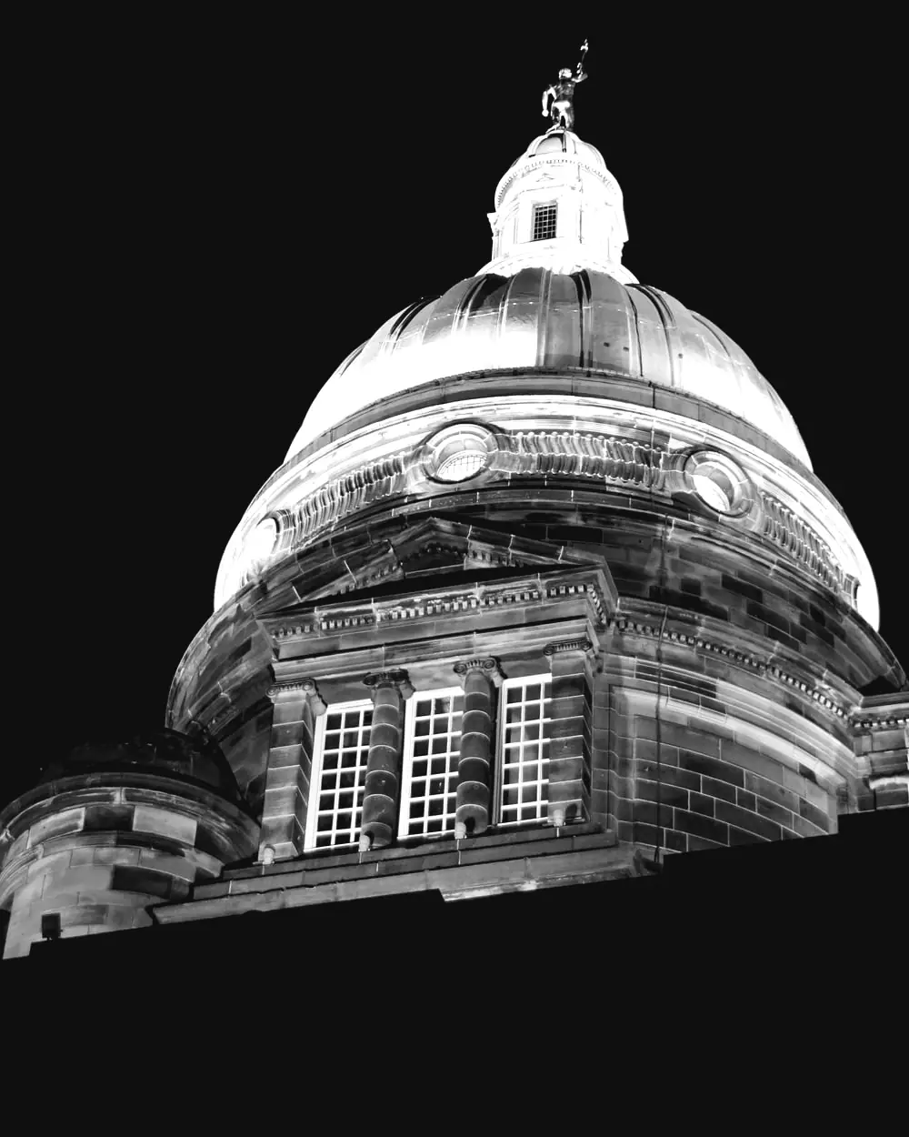 The dome of Old College at the University of Edinburgh, lit against a night sky