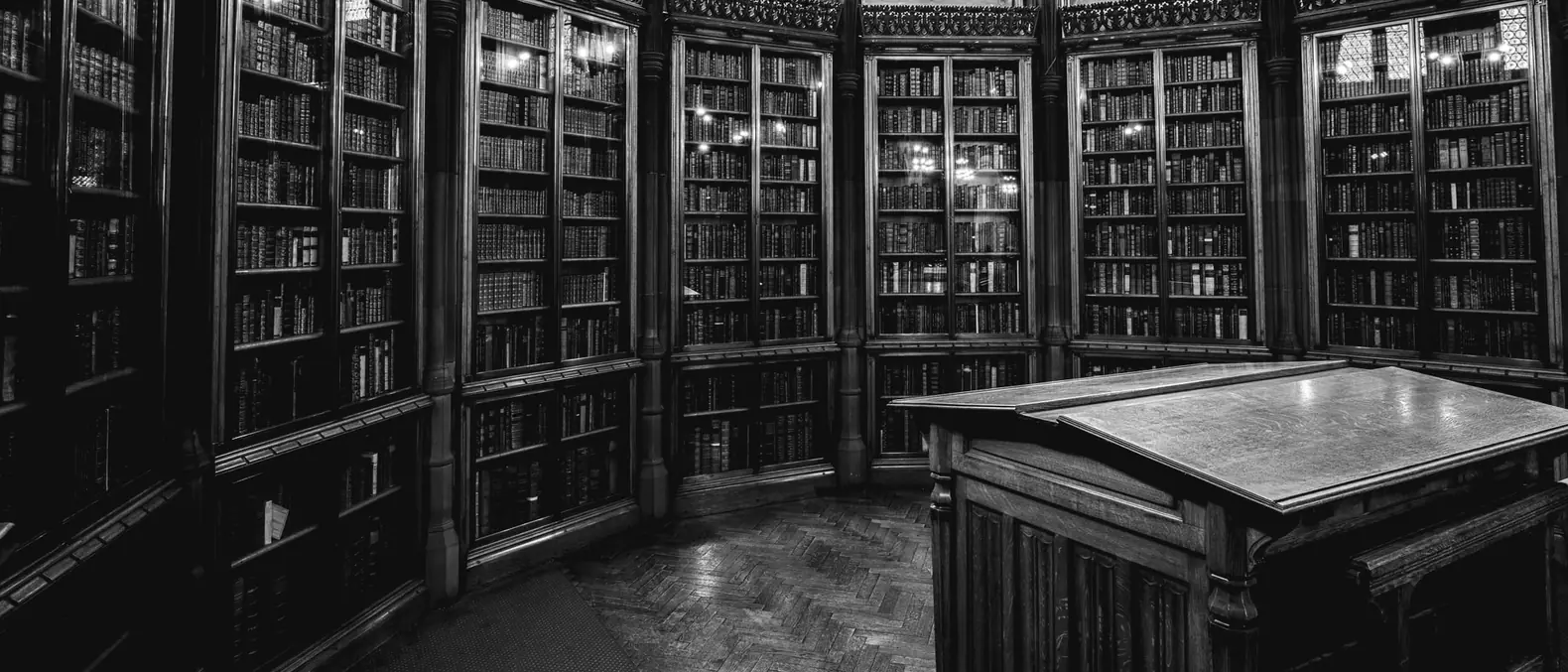 Glass-fronted bookcases and a reading desk in the John Rylands Library, Manchester