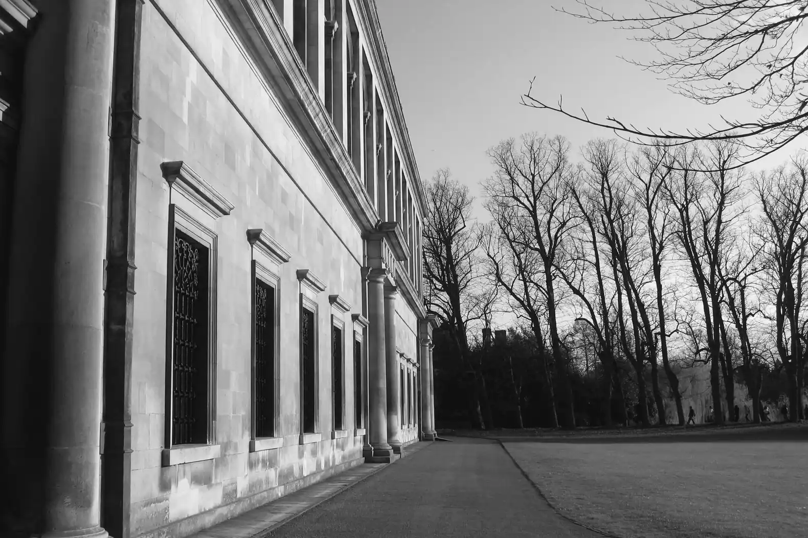 The stone colonnade and long west front of the Wren Library in Cambridge in evening light