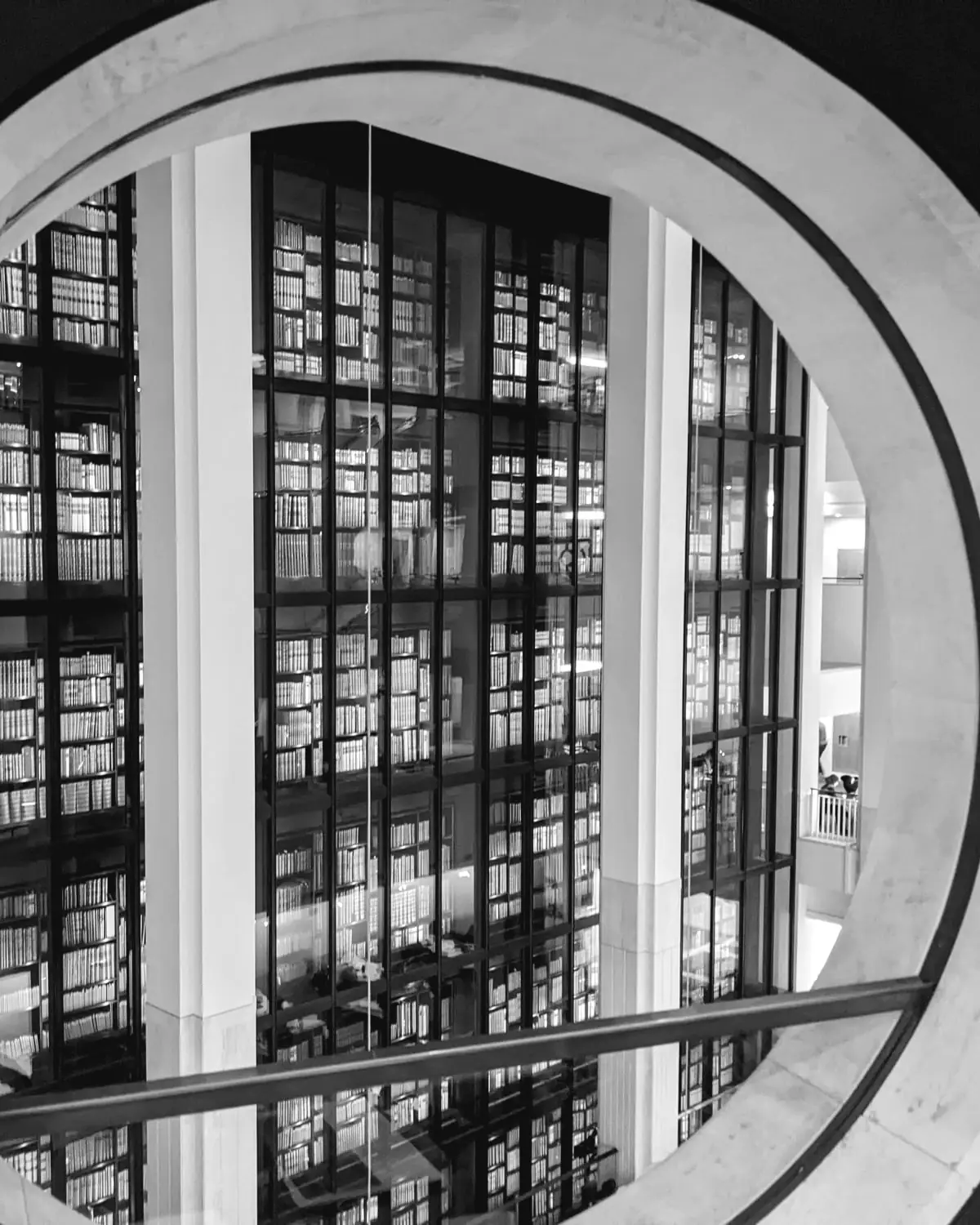 The King's Library tower at the British Library, framed by a round opening in the Members' Room
